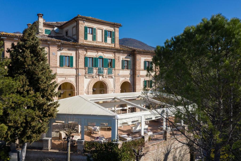 a large brick building with a conservatory in front of it at Marchese Del Grillo in Fabriano