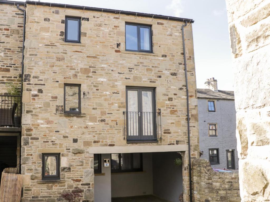 a brick building with a garage in front of it at 9 Navigation Square in Skipton