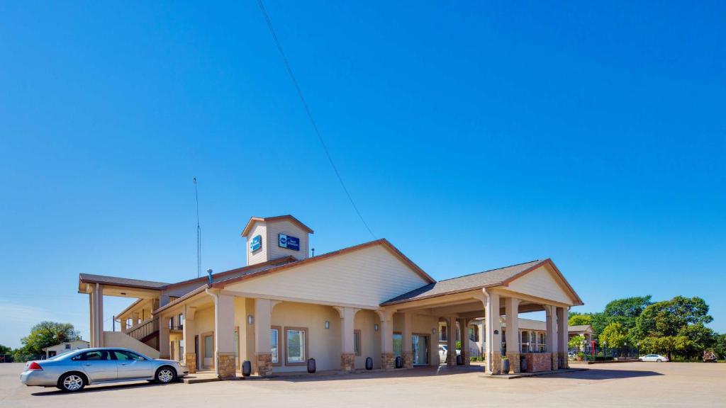 a car parked in front of a building with a clock tower at Best Western Canton Inn in Canton