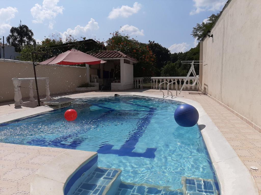 a swimming pool with balls in the water at Valle lanceros Melgar in Melgar