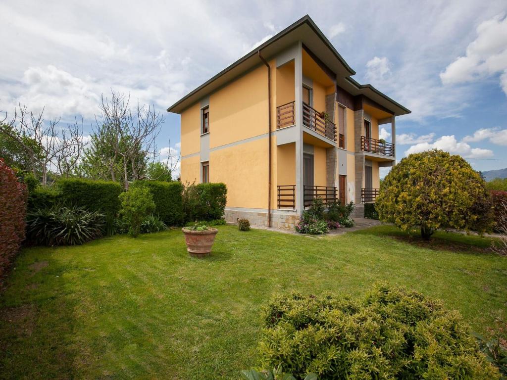 a large house with a yard in front of it at Belvilla by OYO CASA OLMI in Borgo San Lorenzo