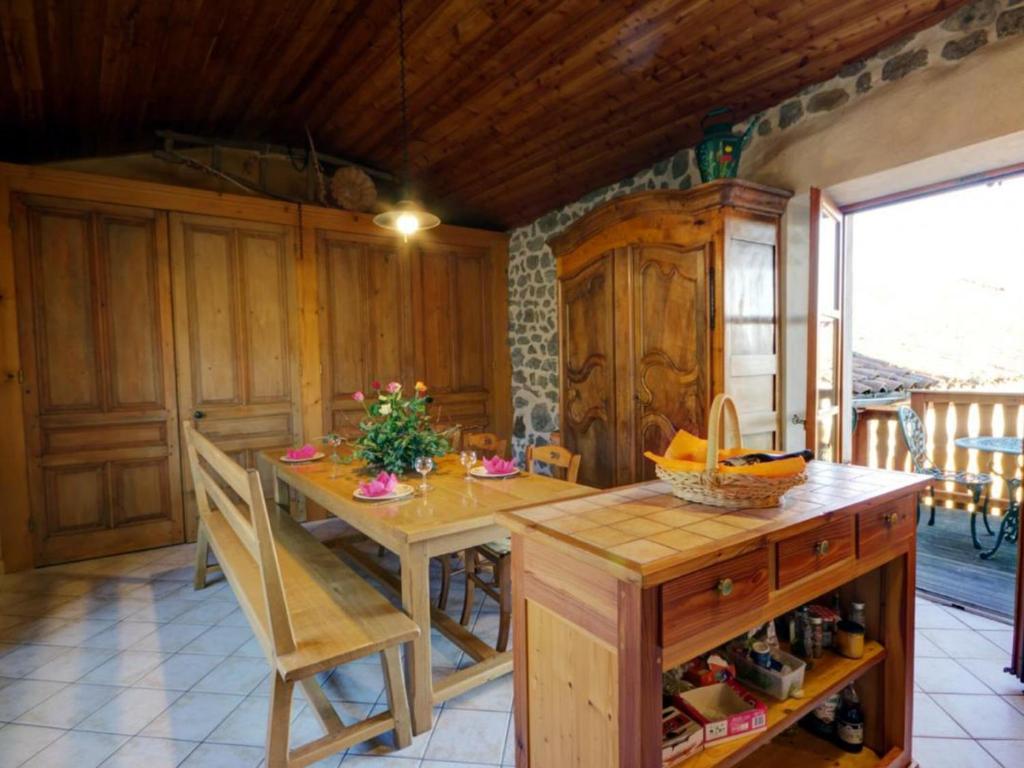 a kitchen with a table and chairs in a room at Gîte Essertines-en-Châtelneuf, 3 pièces, 6 personnes - FR-1-496-16 in Essertines-en-Châtelneuf