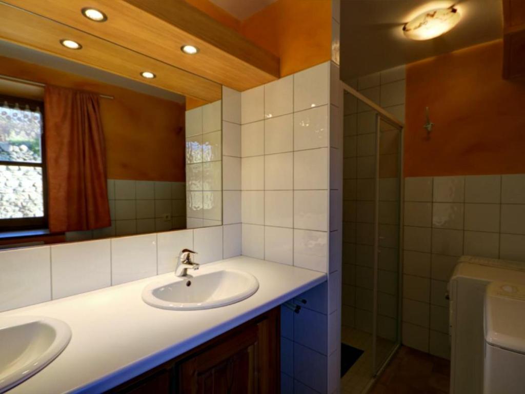 a bathroom with two sinks and a mirror at Gîte Essertines-en-Châtelneuf, 3 pièces, 6 personnes - FR-1-496-16 in Essertines-en-Châtelneuf