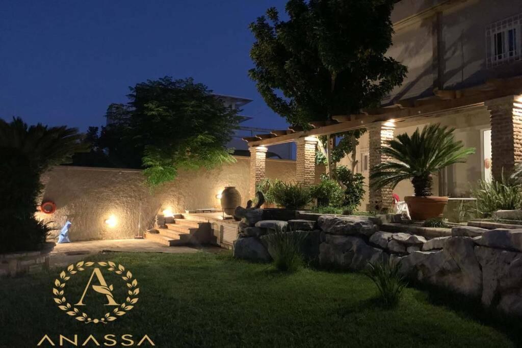 a backyard at night with a landscaping with lights at Swash & Ripple Studio by the sea in Mytikas