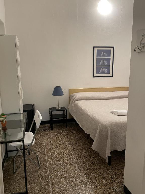 Łóżko lub łóżka w pokoju w obiekcie Albergo Novecento