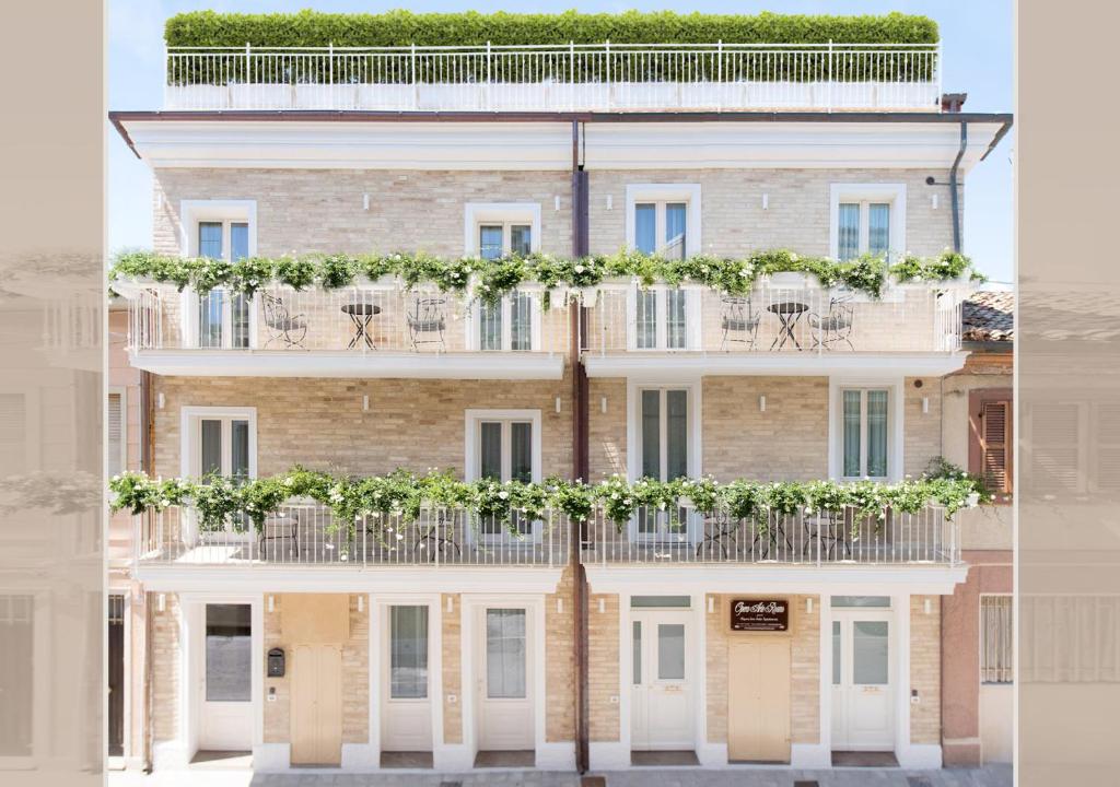 a large building with plants on the balconies at Opera Arte Rooms in Porto Recanati