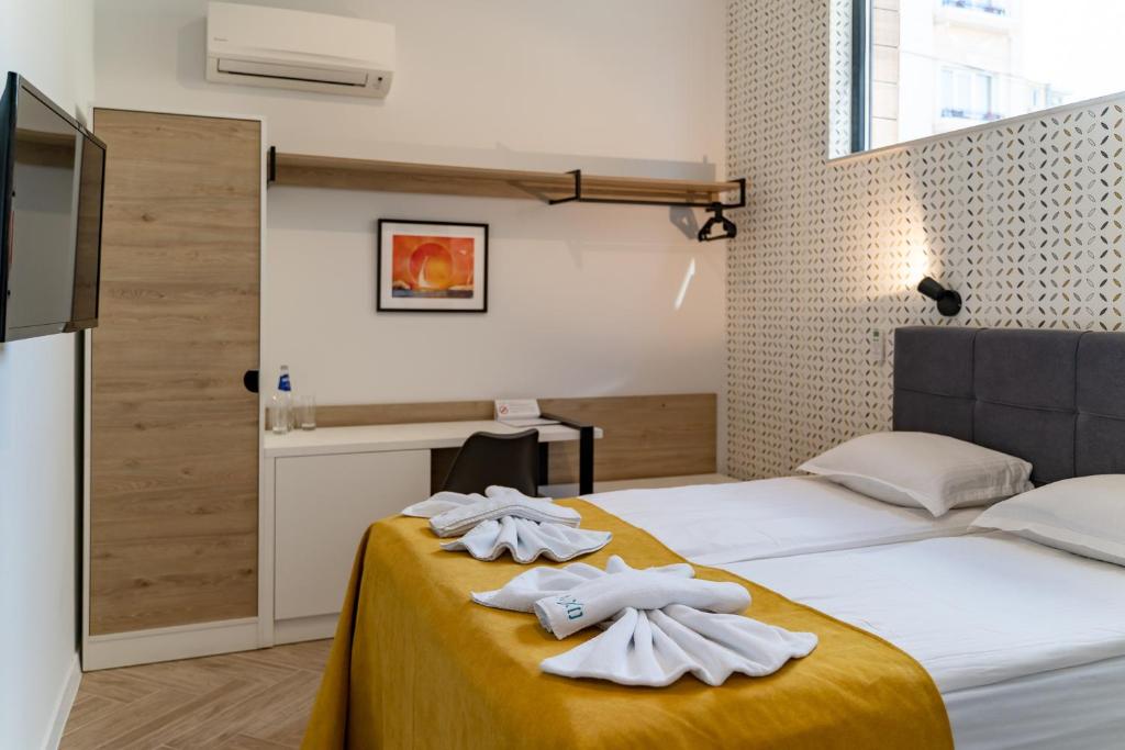 Postel nebo postele na pokoji v ubytování Family Hotel LAXO