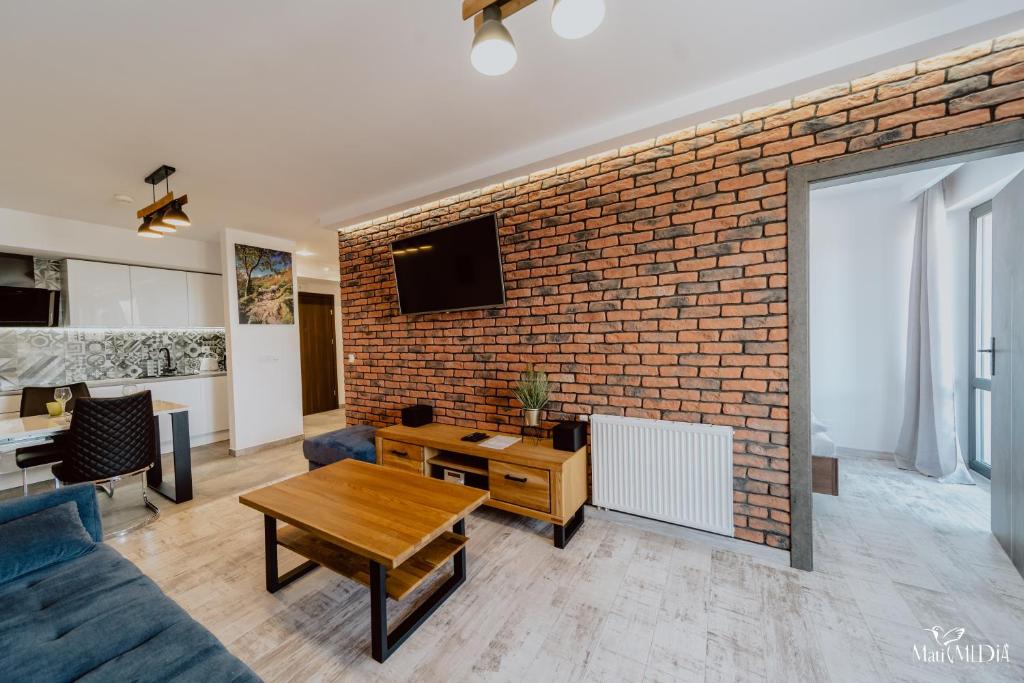 a living room with a brick wall at Apartament Silence Triventi Biały Kot in Karpacz
