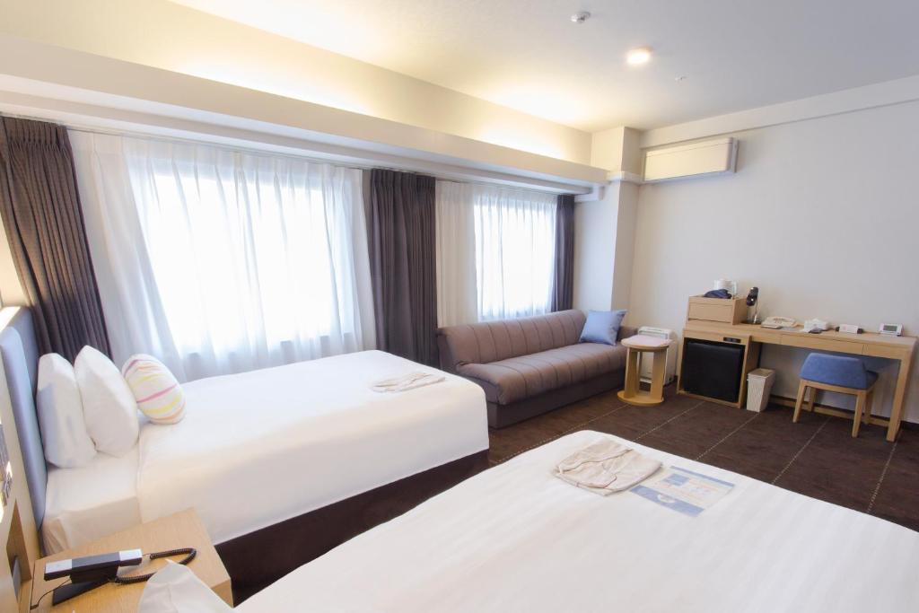 Postel nebo postele na pokoji v ubytování Hearton Hotel Kyoto