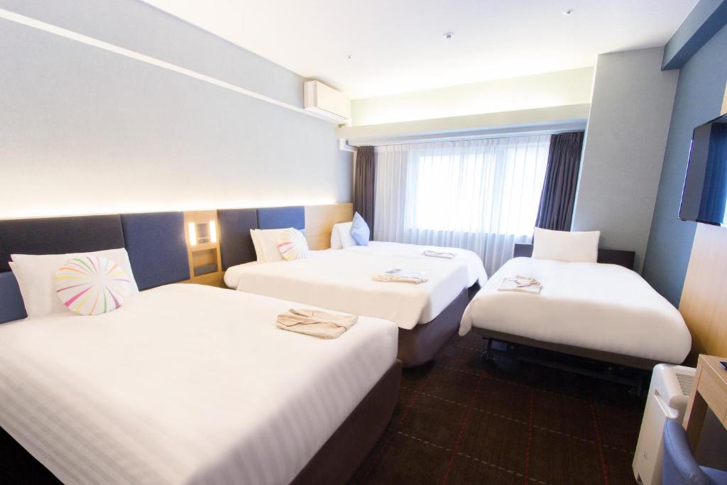Postel nebo postele na pokoji v ubytování Hearton Hotel Kyoto