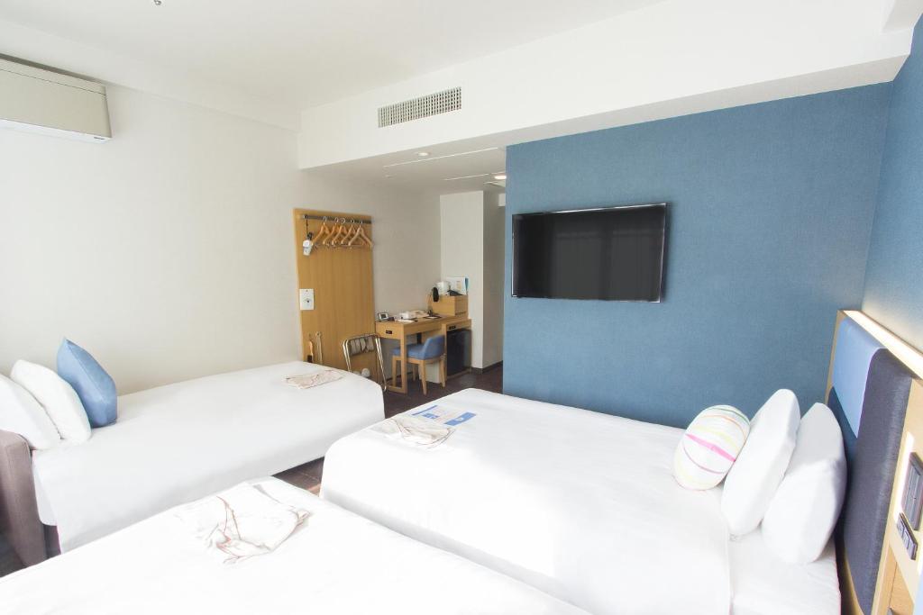 Postel nebo postele na pokoji v ubytování Hearton Hotel Kyoto