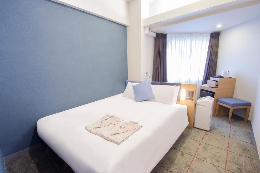 Postel nebo postele na pokoji v ubytování Hearton Hotel Kyoto