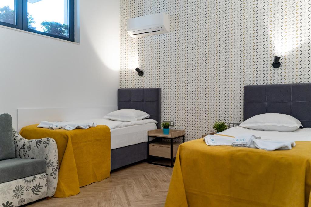 Postel nebo postele na pokoji v ubytování Family Hotel LAXO