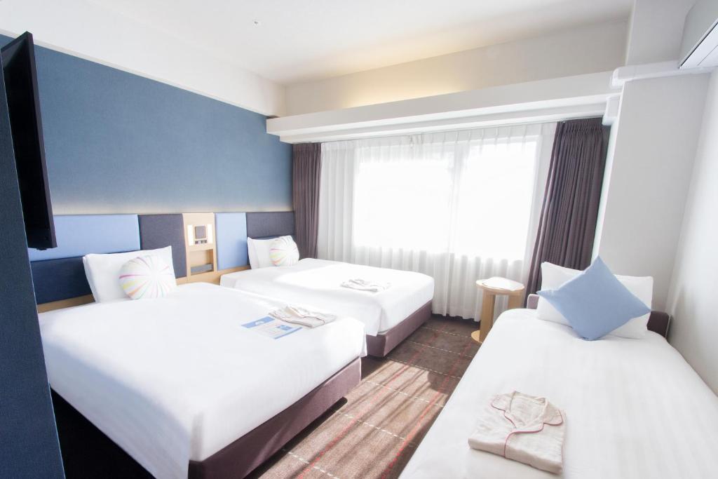 Postel nebo postele na pokoji v ubytování Hearton Hotel Kyoto