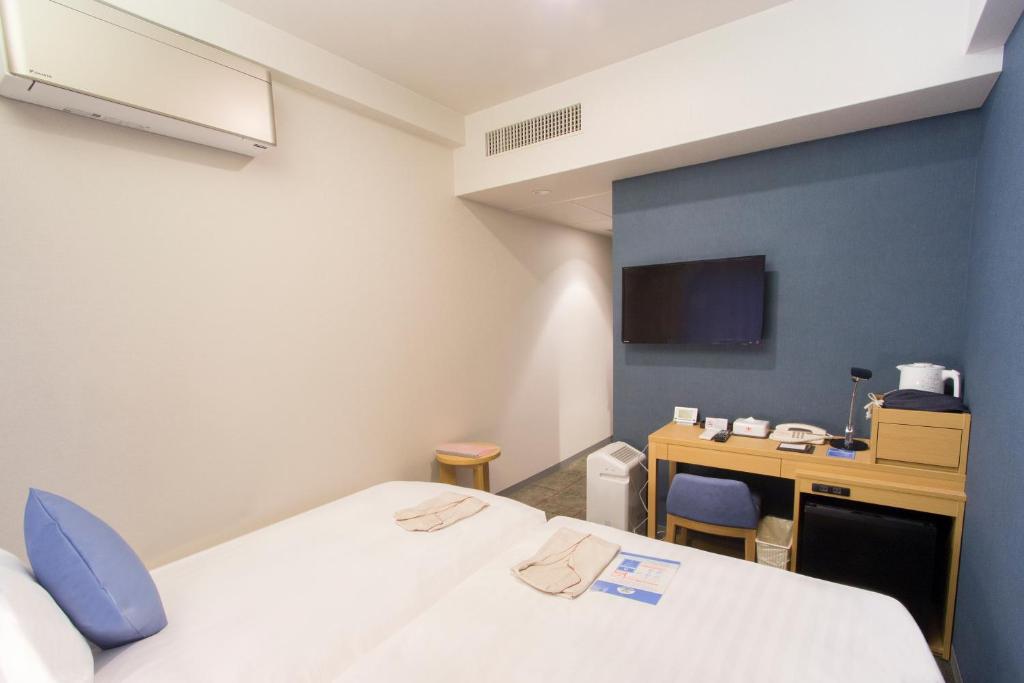 Postel nebo postele na pokoji v ubytování Hearton Hotel Kyoto