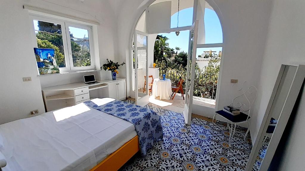 a bedroom with a bed and a window at Villa Dorothee in Capri