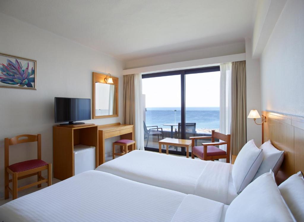 Posteľ alebo postele v izbe v ubytovaní Cactus Hotel