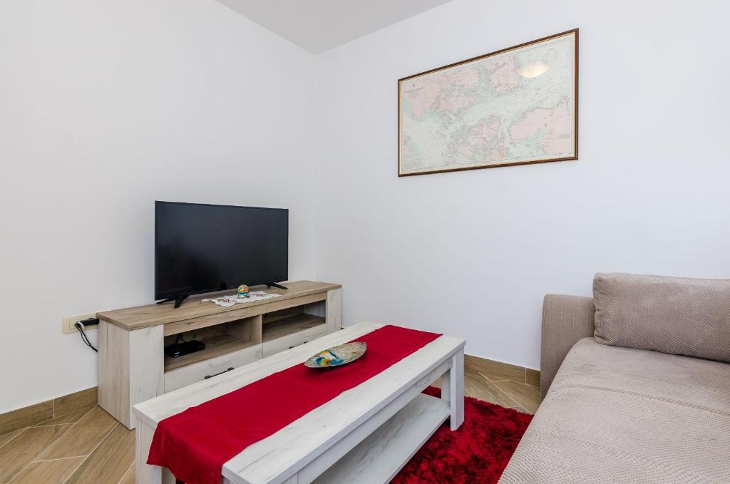 Televízia a/alebo spoločenská miestnosť v ubytovaní Carpe Diem Apartments