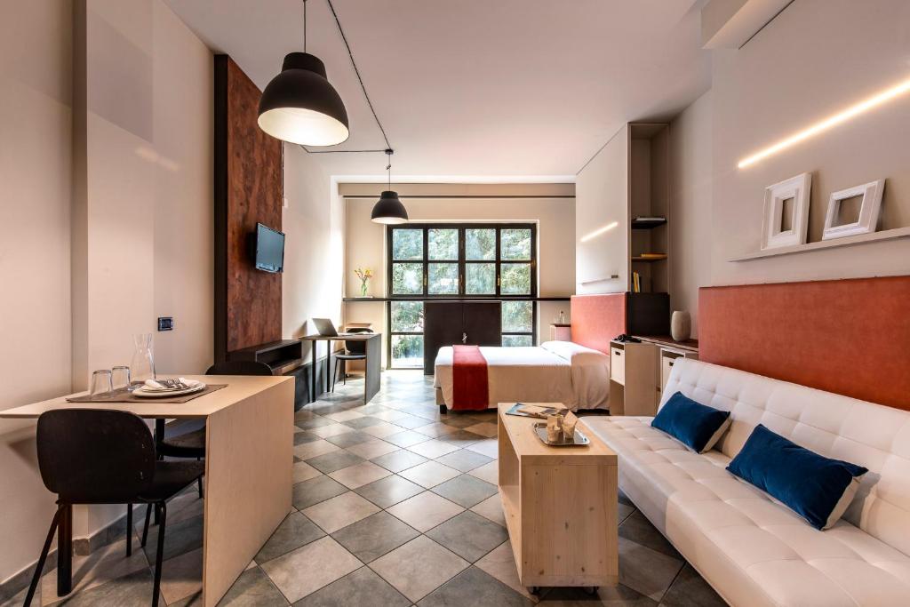 a hotel room with a couch and a bed at Residence 2Gi in Milan