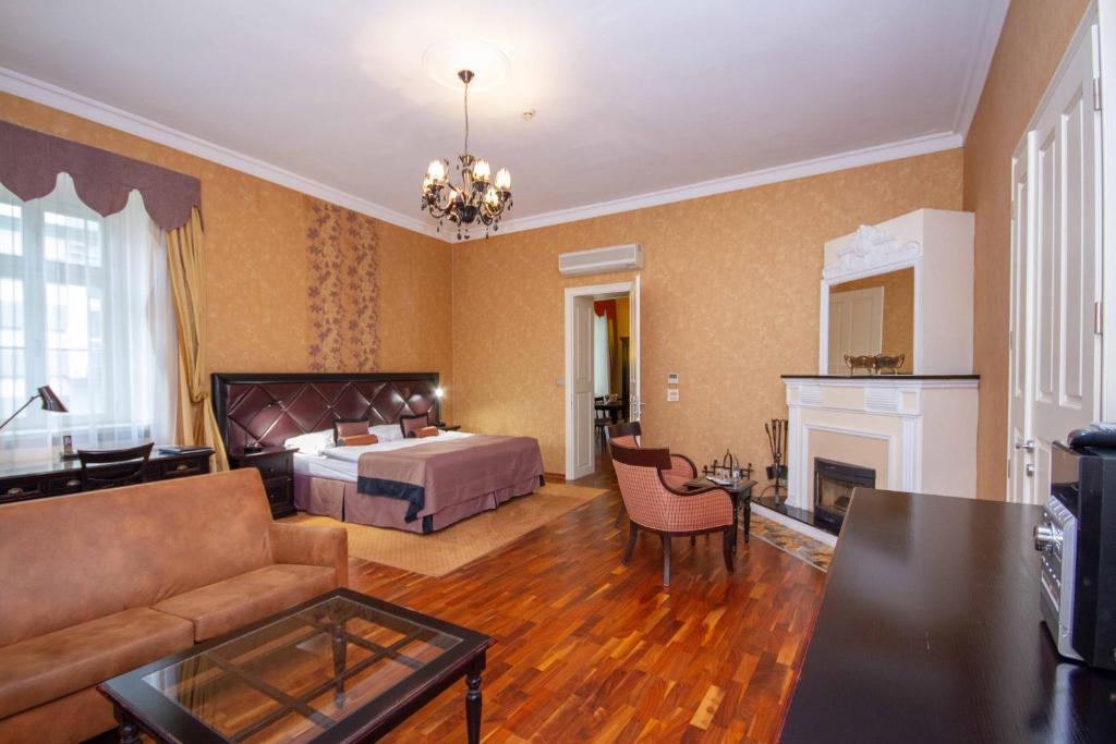 
a living room filled with furniture and a fireplace at Luxury apartments in the historical building in the heart of Old Town in Bratislava
