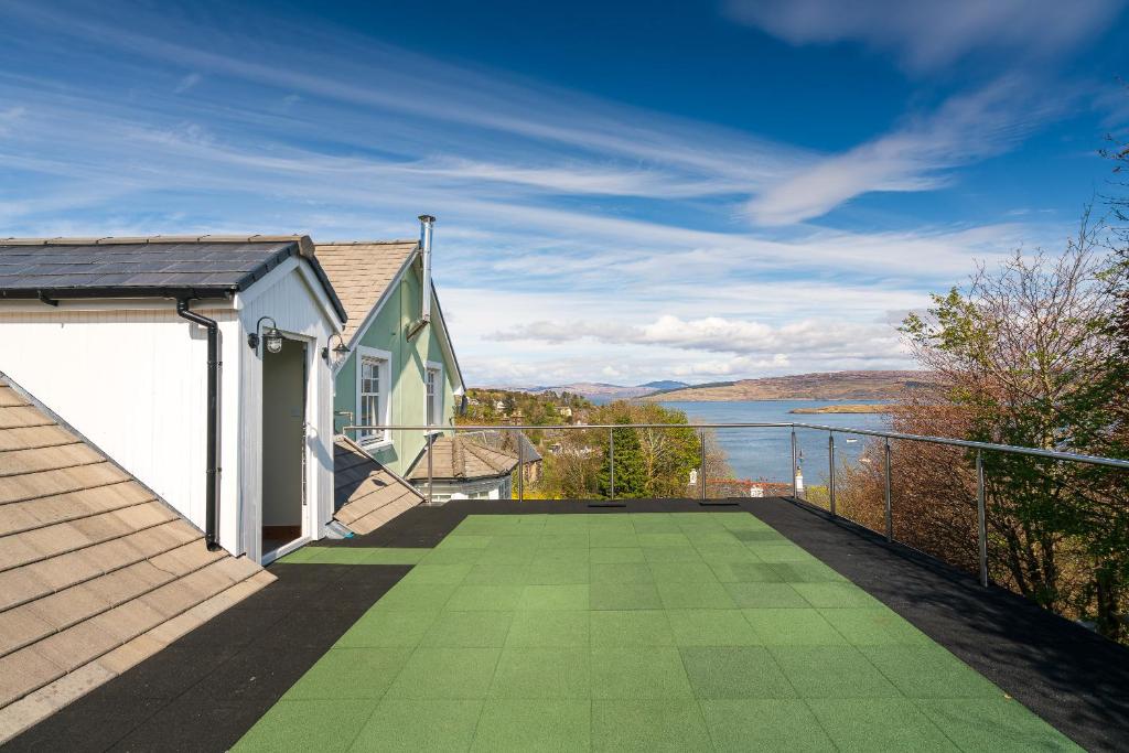 a balcony of a house with a view of the water at Morvern in Tobermory