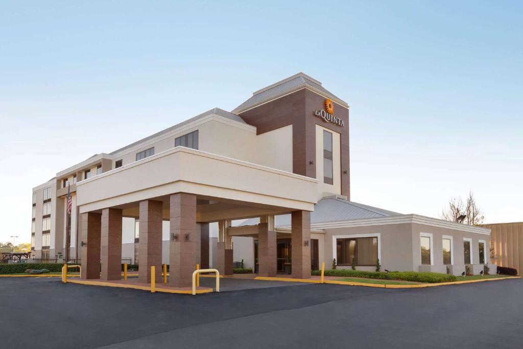 a large white building with a sign on it at La Quinta inn & suites by Wyndham Dothan in Dothan