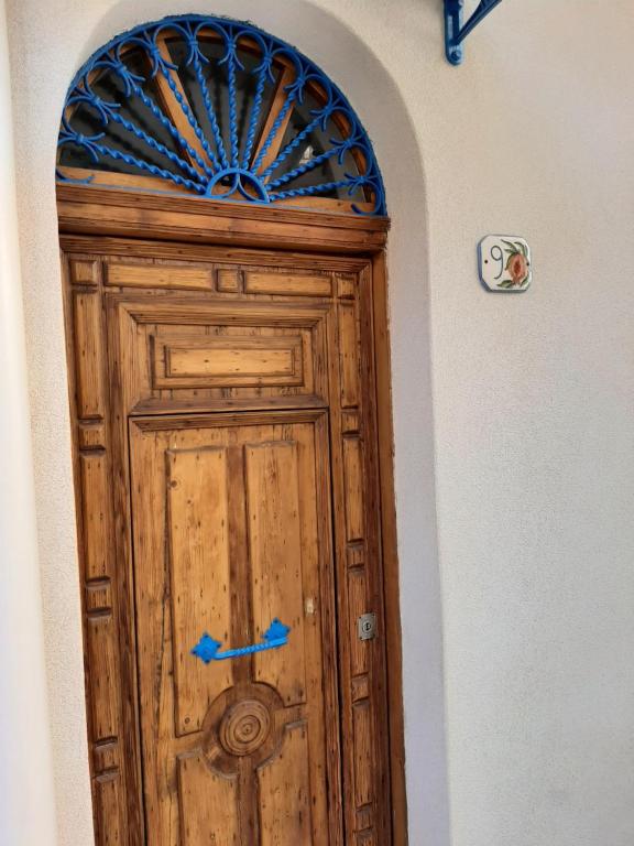 a wooden door in a wall with a window at La Melagrana in Castellammare del Golfo