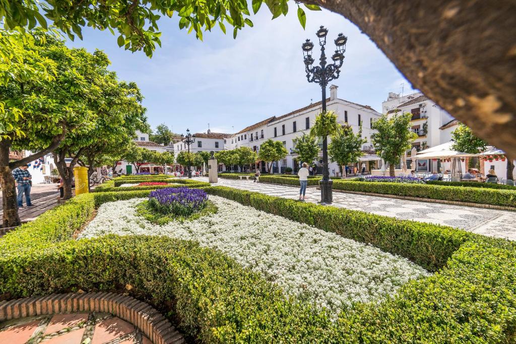 a view of a park with white flowers at Óbal Hotel Marbella in Marbella