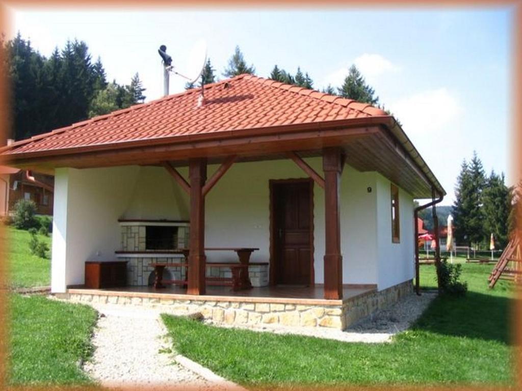 a gazebo with a table in front of a house at Motylek 4 in Borušov