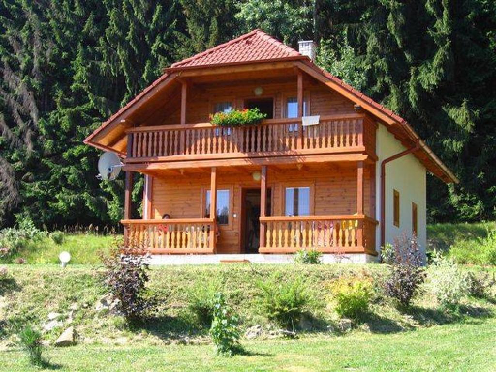 a log cabin with a porch and a balcony at Motylek 8 in Borušov