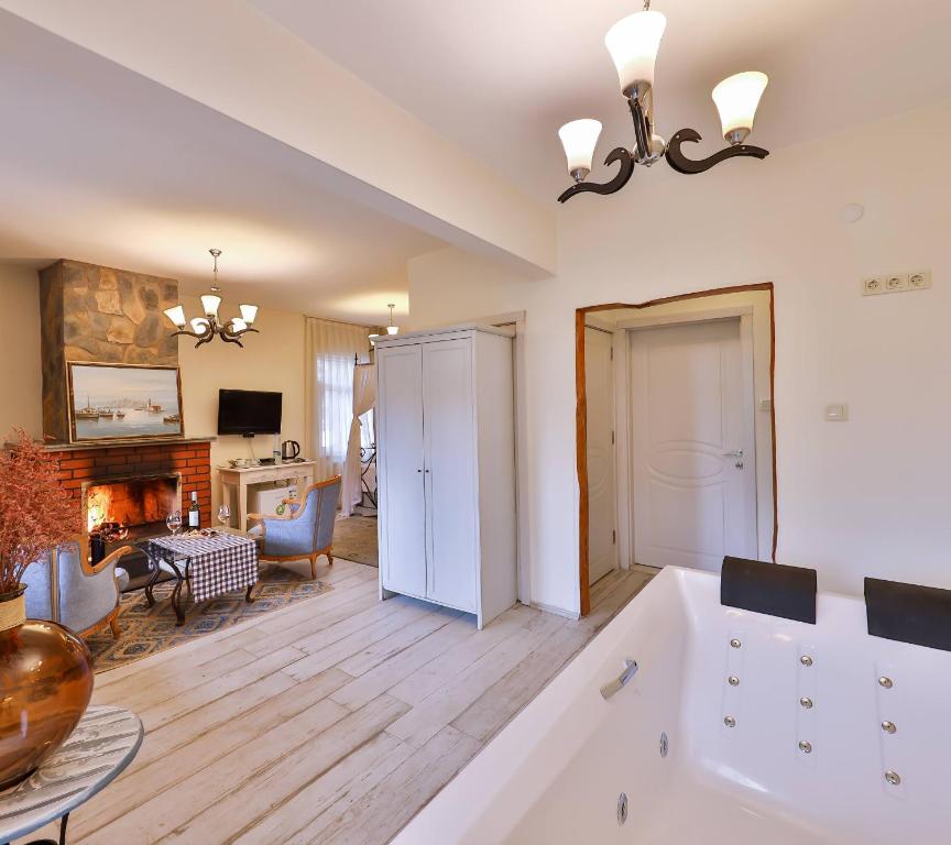 a large bathroom with a tub and a living room at Park Mandalin Hotel - Adult only in Ağva