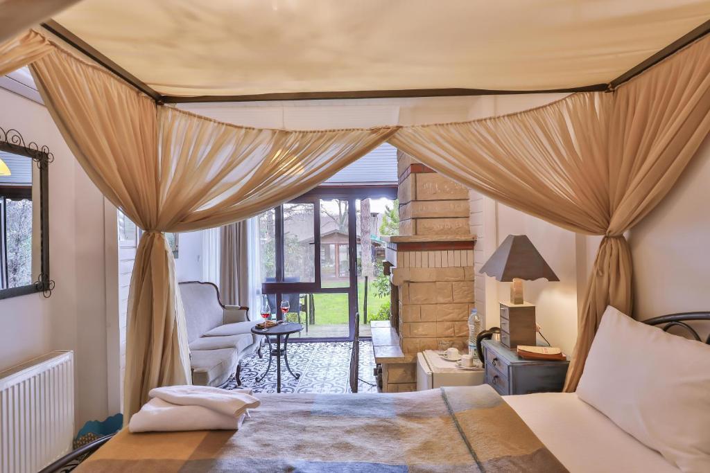 a bedroom with a bed with curtains and a chair at Park Mandalin Hotel - Adult only in Ağva