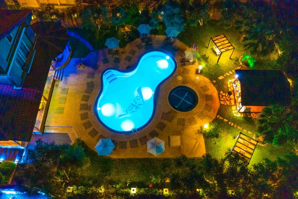 an overhead view of a house with a swimming pool at night at Mesken Inn Hotel in Göcek