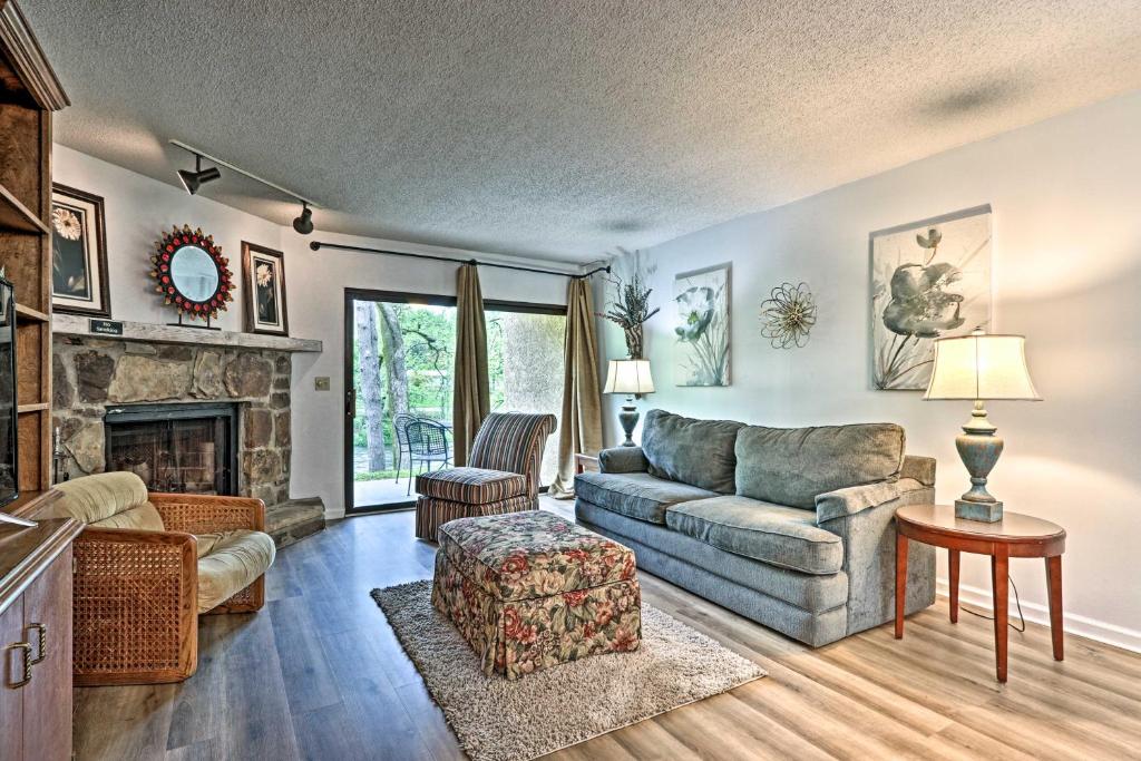 a living room with a couch and a fireplace at Riverside Condo 2 Miles to Smoky Mtns Ntl Park! in Townsend