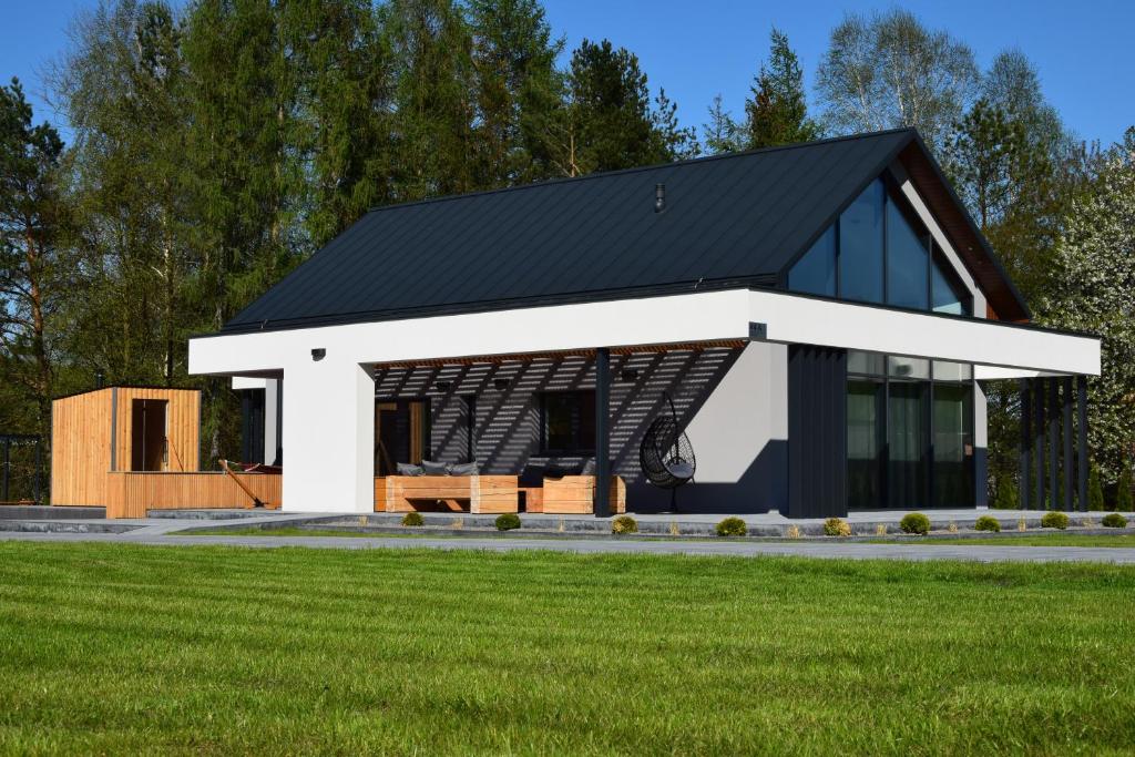 a rendering of a house with a black roof at Szklane Domy Roztocze 2 in Bondyrz