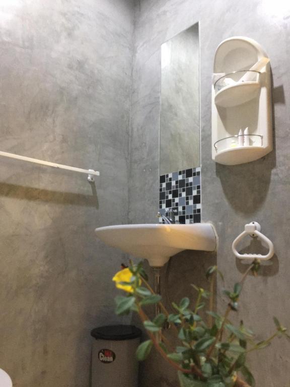 a bathroom with a sink and a mirror at Rawai Whale Resort in Rawai Beach