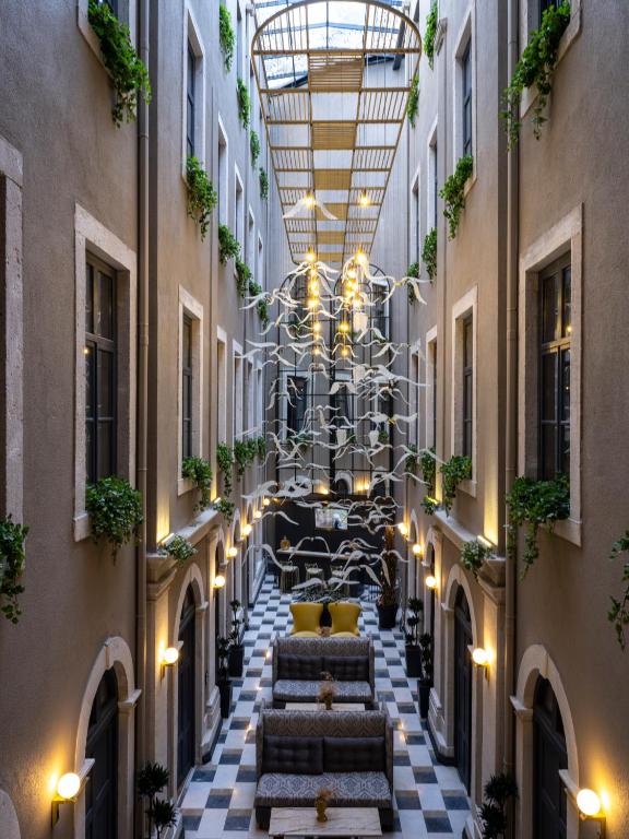 an internal courtyard of a building with a chandelier at Ferman Port Hotel - Special Category in Istanbul