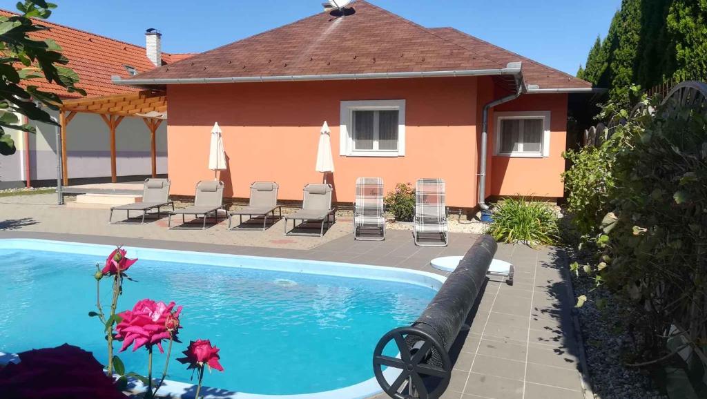 a swimming pool in front of a house at Holiday home in Balatonszentgyörgy 20188 in Balatonszentgyörgy