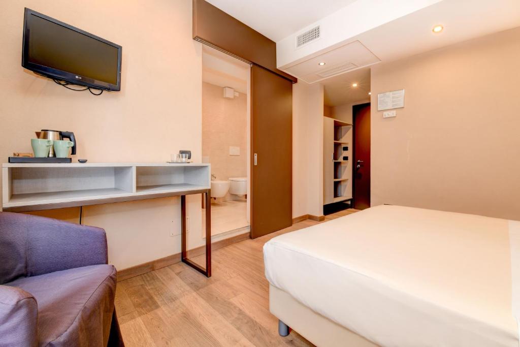 Postel nebo postele na pokoji v ubytování Hotel Tripoli
