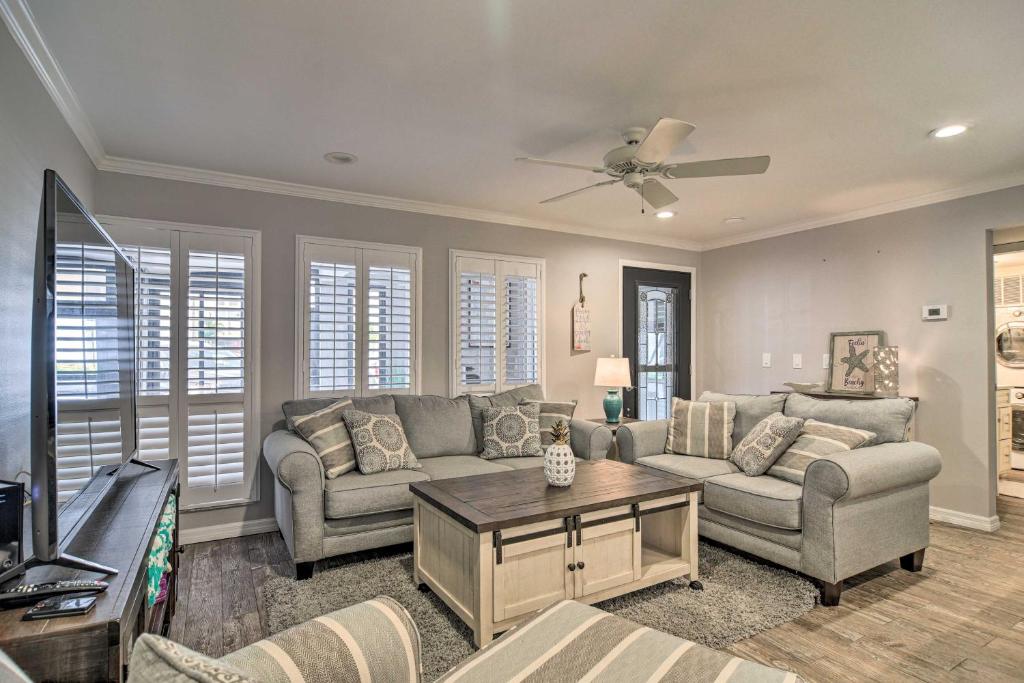 a living room with a couch and a table at Elegant FL Condo with Pool Walk to Madeira Beach! in St. Pete Beach