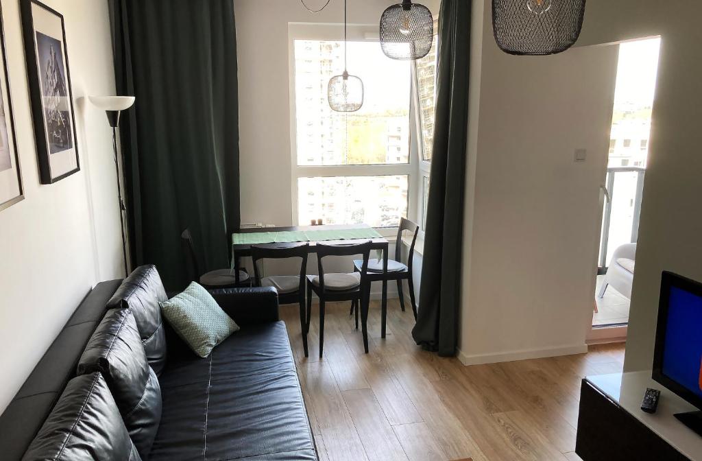a living room with a couch and a table at Apartament 47 Letnica in Gdańsk