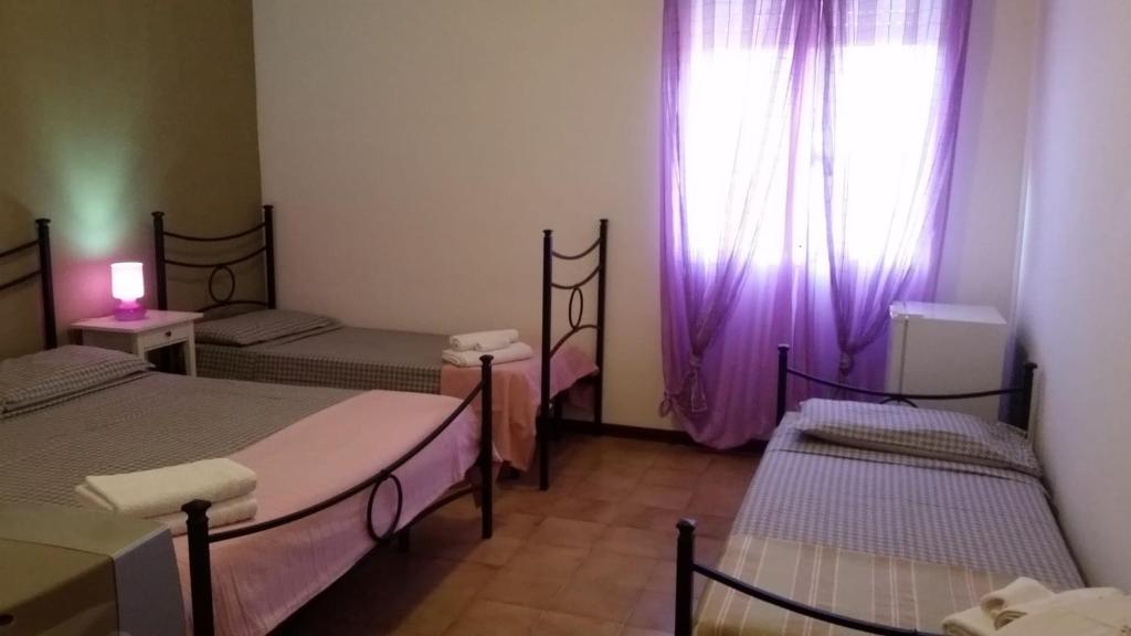 Postel nebo postele na pokoji v ubytování B&B Salvatore Lido di Noto