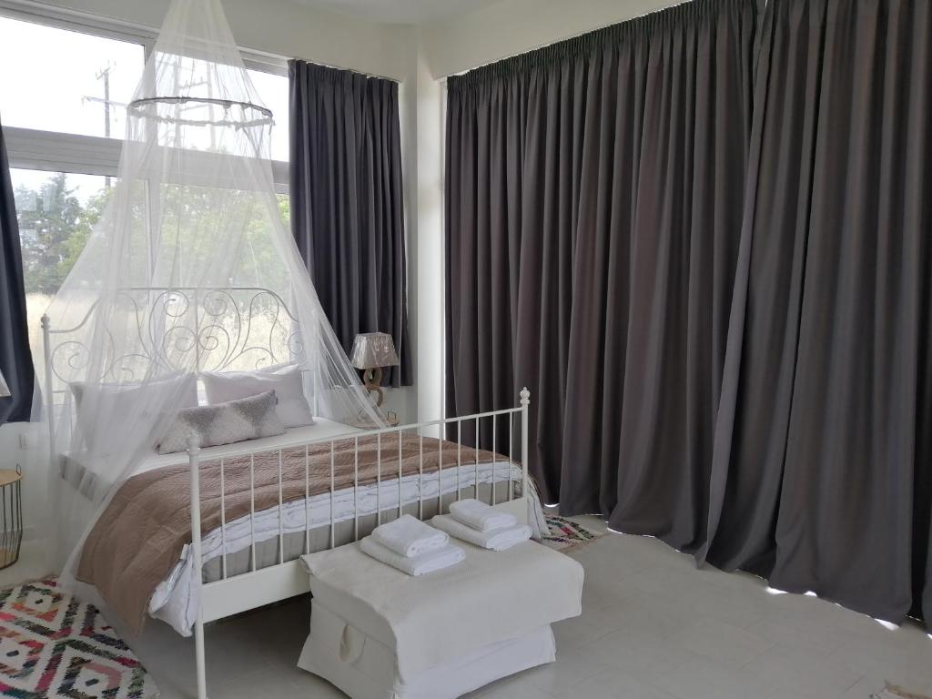 a bedroom with a white bed and a window at Spacious Beach House Theologos in Theologos