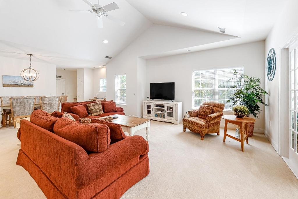 a living room with two couches and a tv at Golfmaster D2 in Hilton Head Island