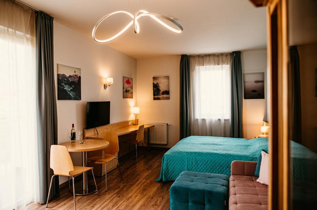 TV a/nebo společenská místnost v ubytování Tagore Spa Aparthotel