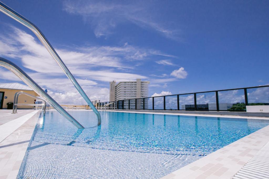 a swimming pool on the roof of a building at Vistalmar Beach Resort in Deerfield Beach