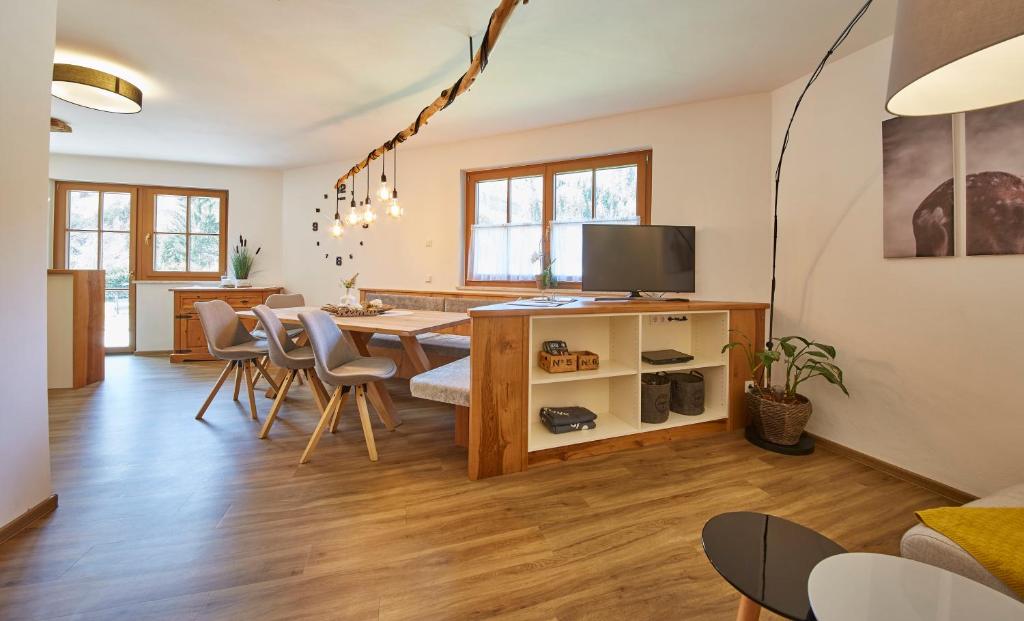 a living room with a dining room table and chairs at Hochwart Apartment - Familienapartments in Saalbach-Hinterglemm