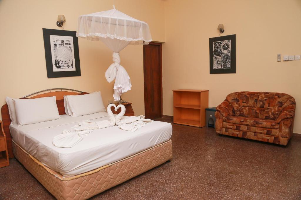 a bedroom with a bed with a swan decoration on it at Milano Tourist Rest in Anuradhapura