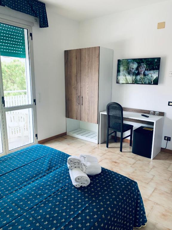 Postel nebo postele na pokoji v ubytování Hotel Al Capitano