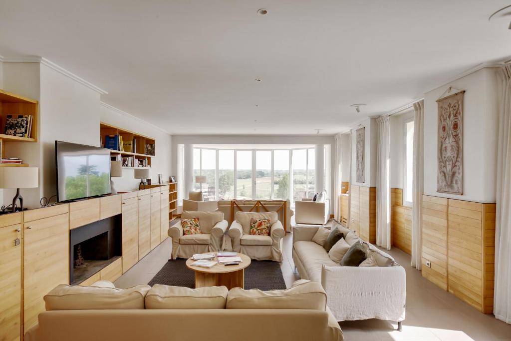 a living room with a couch and a fireplace at Le logis de Valandraud in Saint-Émilion